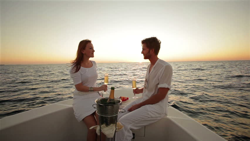 Cheerful Couple Cruising On A Catamaran In Caribbean Sea 