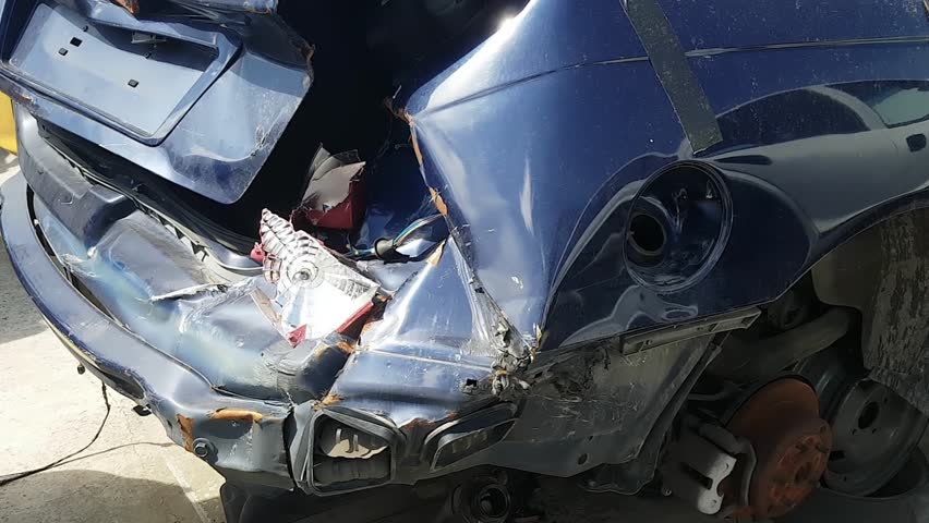Slowing Footage Of A Smashed Up Blue Car With Broken Tail Light