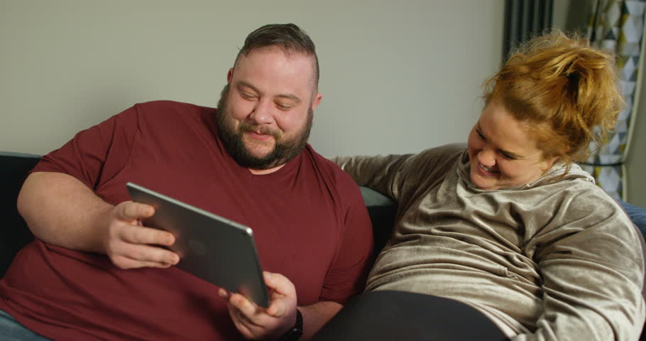 4k00 274k Happy Couch Potato Couple Laughing At Funny Movie