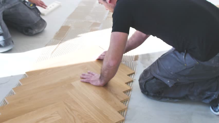Process Of Laying Of Parquet Floor Handyman At Work Gluing Of