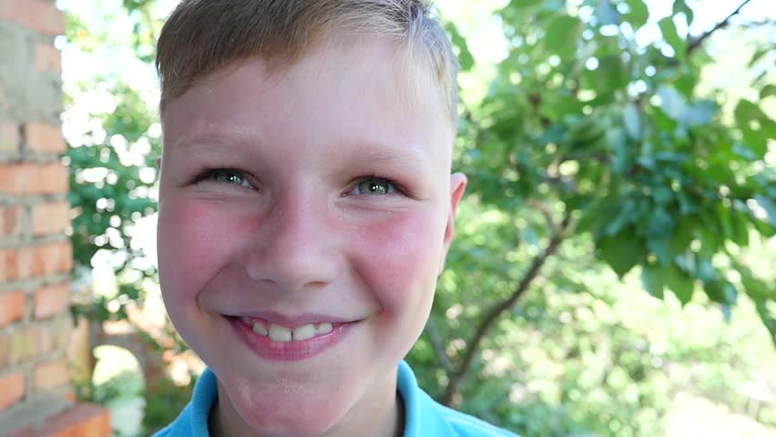 beautiful boy looks at the camera and smiling over green background slow motion hd stock - Little Kid Pictures beautiful boy looks at the camera and smiling over green background slow motion hd stock - Little Kid Pictures