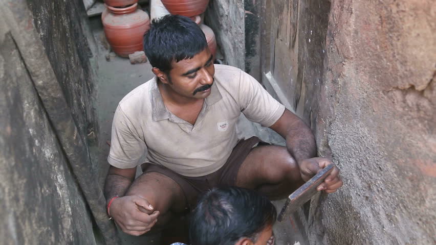 Portrait Of Cheerful Male Potter Working With Clay On Pottery Wheel In