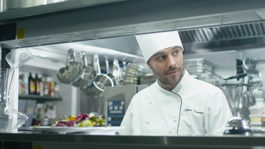 Restaurant Kitchen Video smiling chef cooking in restaurant kitchen, host on cooking show Restaurant Kitchen Video smiling chef cooking in restaurant kitchen, host on cooking show
