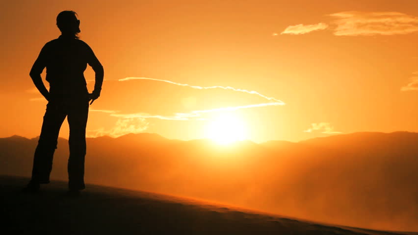 Solitary Female Hiking Across Sand Dunes In A Desert Environment Stock ...