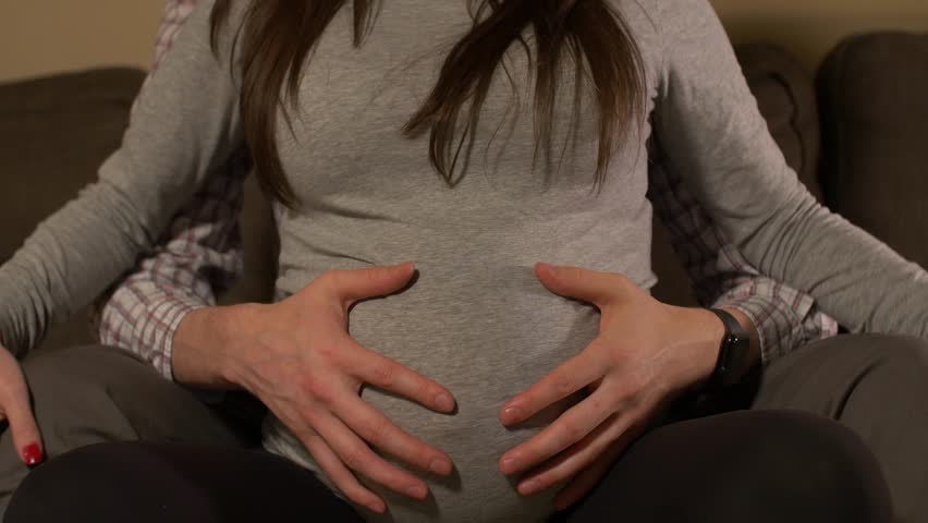 Pregnant Woman Taking Mans Hands And Rubbing On Belly Stock Footage Video 13446401 Shutterstock 