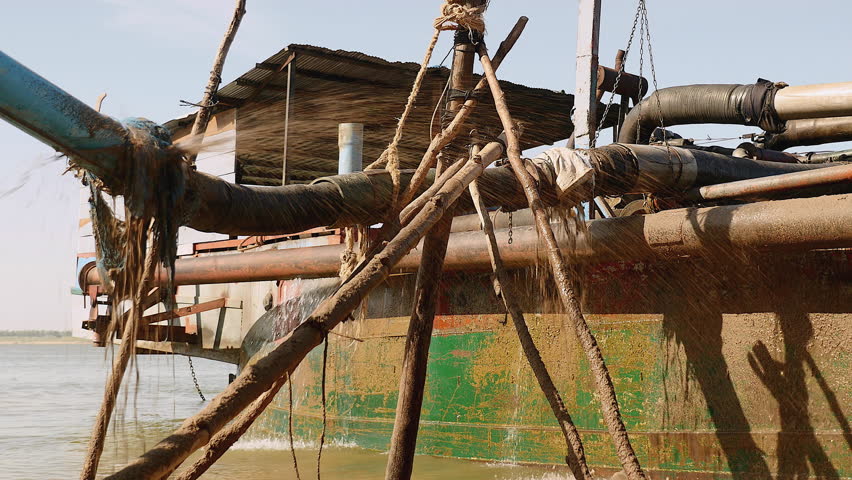 Close Up Of A Dredging Boat Tied To Shore; Sand Is Being Pumped Out Of ...