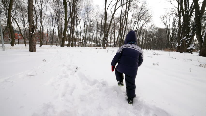 Young Child And Mother Bundled Up In Winter Gear, Walk In Snow Storm In ...