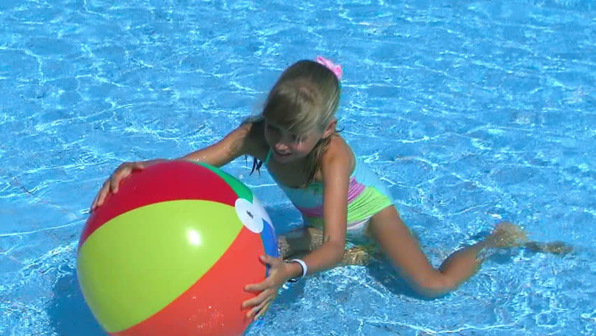 Pool Water With Beach Ball children with beach ball in swimming pool. stock footage video Pool Water With Beach Ball children with beach ball in swimming pool. stock footage video