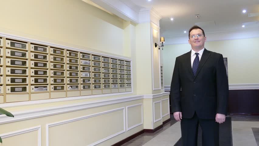 Apartment Building Mailboxes apartment concierge: man on mailboxes background stock footage Apartment Building Mailboxes apartment concierge: man on mailboxes background stock footage