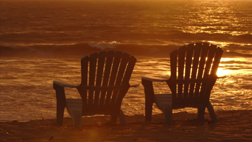 Caucasian Couple Sitting On Two Camping Chairs Looking At Beautiful ...