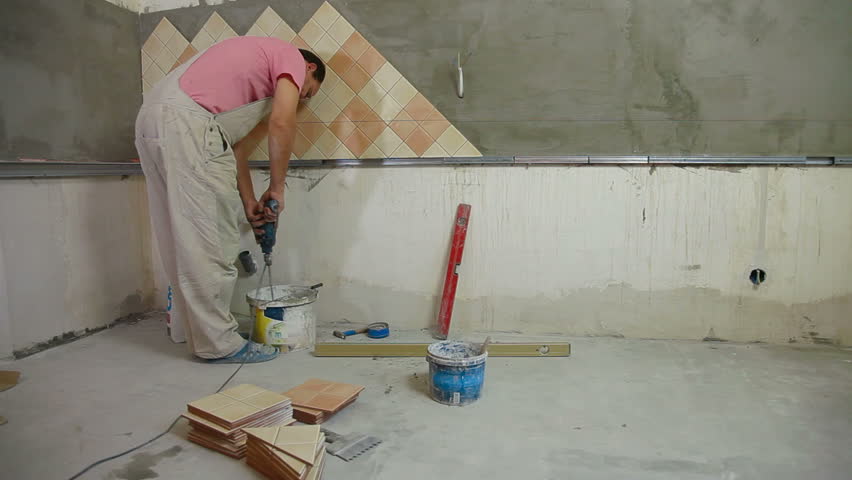 Man Installs Ceramic Tile Stock Footage 100 Royalty Free Man Installs Ceramic Tile Mixing Grout Wide Angle Rear View