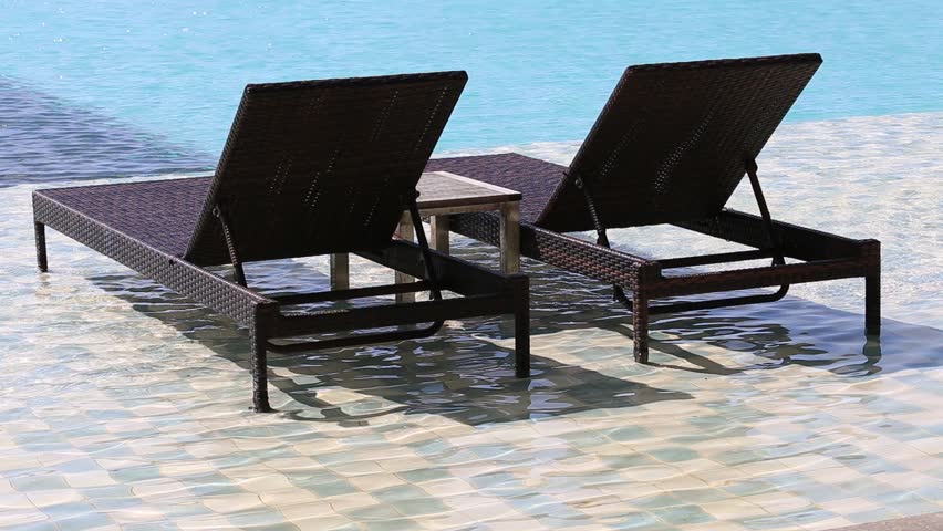 two deck chairs in the swimming pool at a tropical resort hd stock video clip - Swimming Pool Deck Chairs two deck chairs in the swimming pool at a tropical resort hd stock video clip - Swimming Pool Deck Chairs