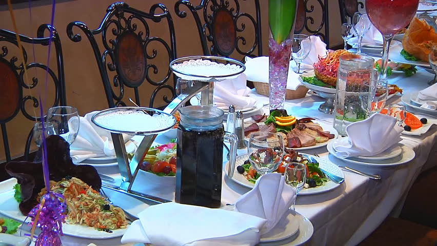 Dining Table With Food panning shot of place setting at wedding reception. food and Dining Table With Food panning shot of place setting at wedding reception. food and