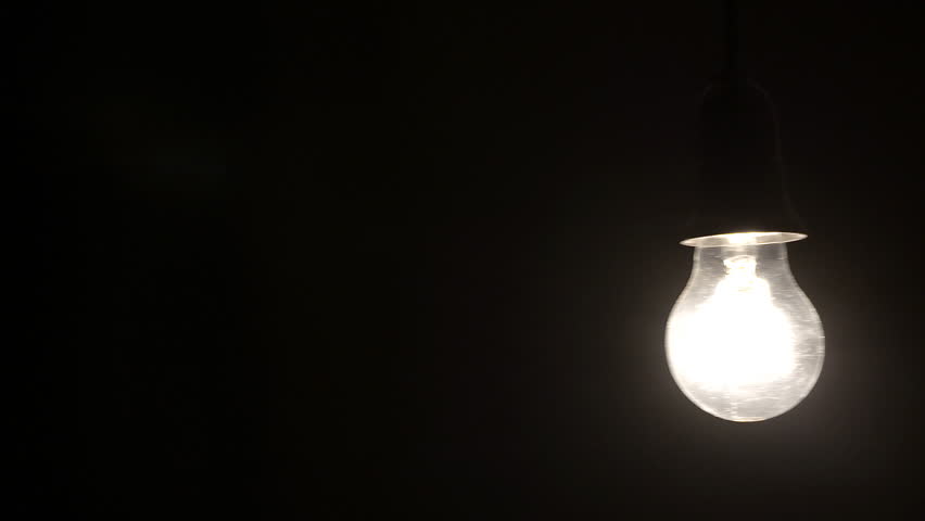 close up of tungsten light bulb being turned off to black close up of tungsten light bulb being turned off to black