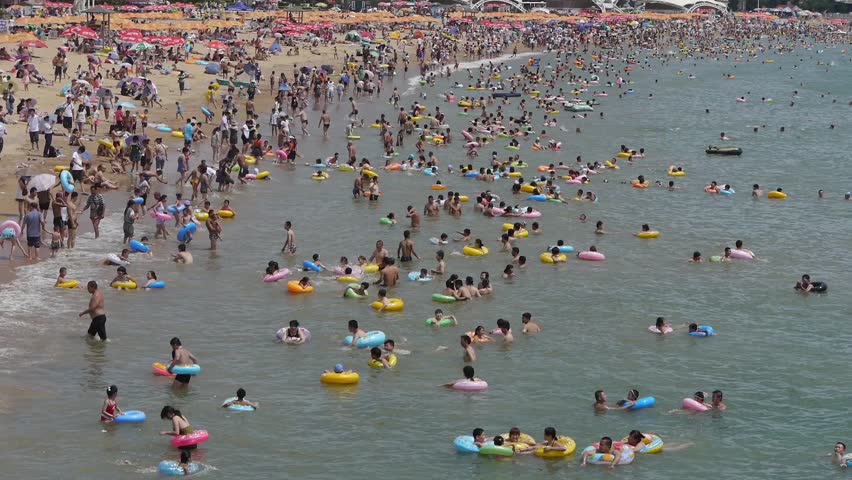 A Lot Of People At Crowded Bathing Sandy Beach.People Swim In Sea,China ...