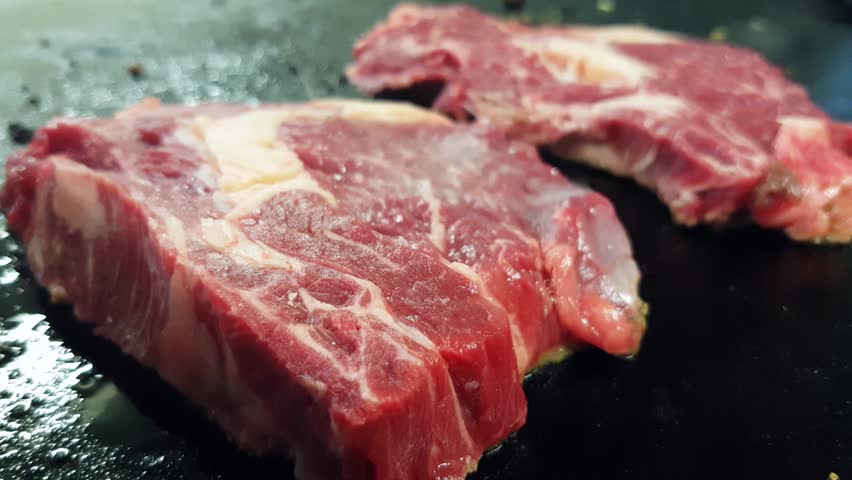Restaurant Kitchen Video black angus entrecote beef steaks, on a frying pan, in a Restaurant Kitchen Video black angus entrecote beef steaks, on a frying pan, in a