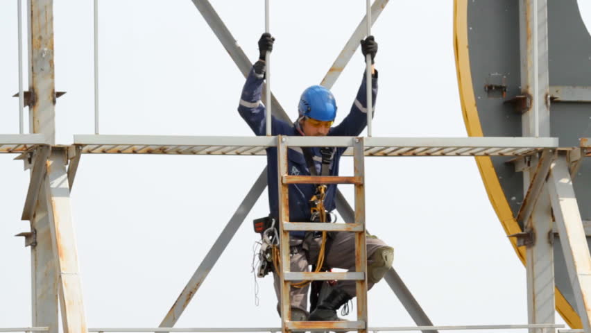 High-Altitude Work. The Man In Special Clothes And Helmet Holds The ...