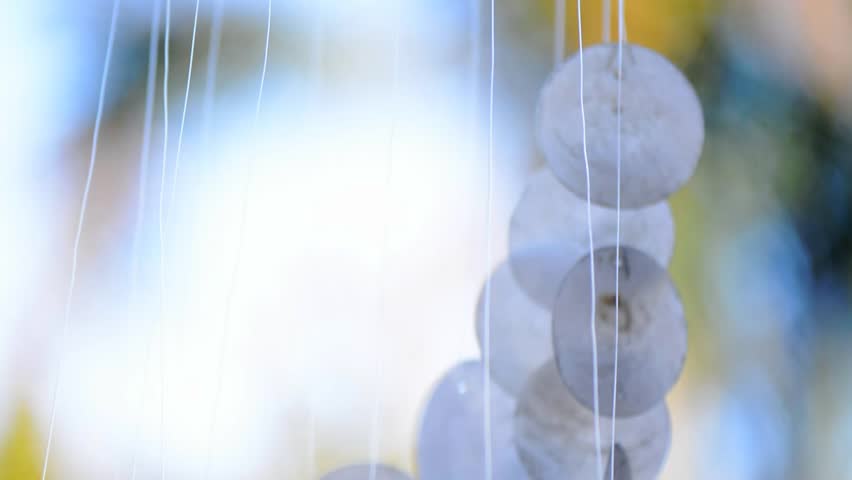 Wind Chimes Stock Footage Video Shutterstock Macro Closeup Of Moving Capiz Shell Wind Chimes Against Bokeh Sunlight Garden Background Panning Down