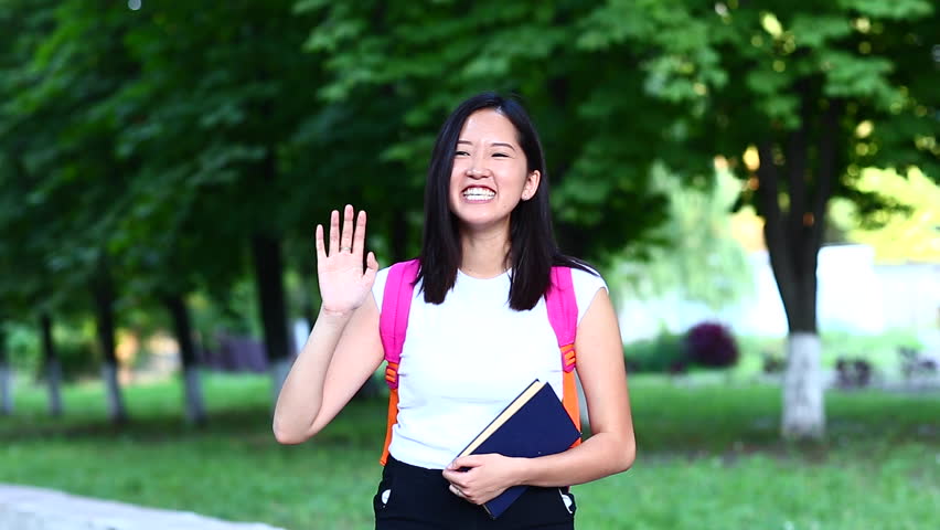 Woman Waves Hand And Smiles Stock Footage Video 100 Royalty Free