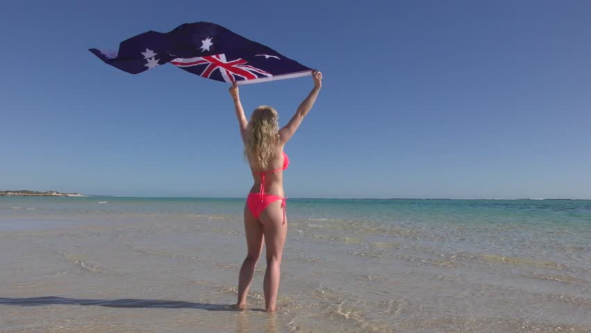 happy-attractive-sexy-young-blonde-bikini-woman-standing-at-beautiful