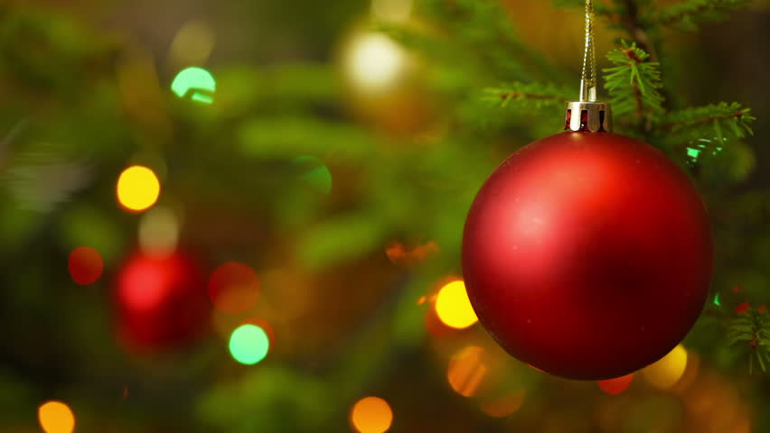 A Red Bauble Ornament Hanging On A Christmas Tree, With Other ...