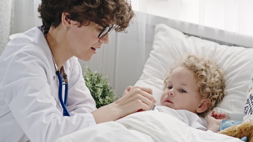 4k00 23little Toddler Boy With Curly Hair Lying In Bed Pretending To Be