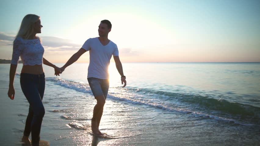 Honeymoon Passionate Couple Kissing On The Beach. Beautiful Sunset ...