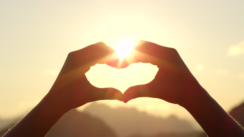 Slow Motion. Woman Shapes Heart With Hands Over Sun On Sunrise Or ...