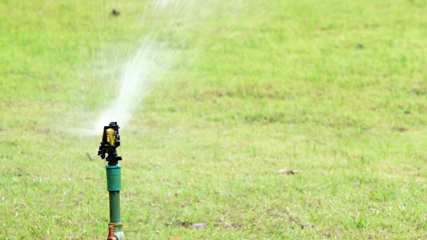 Sprinkler And Naked Child Running Through It Stock Footage 