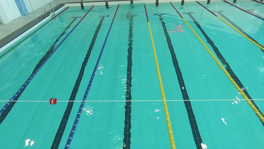 flight over male swimmer swims in a pool hd video calm water surface professional - Olympic Swimming Pool Underwater flight over male swimmer swims in a pool hd video calm water surface professional - Olympic Swimming Pool Underwater