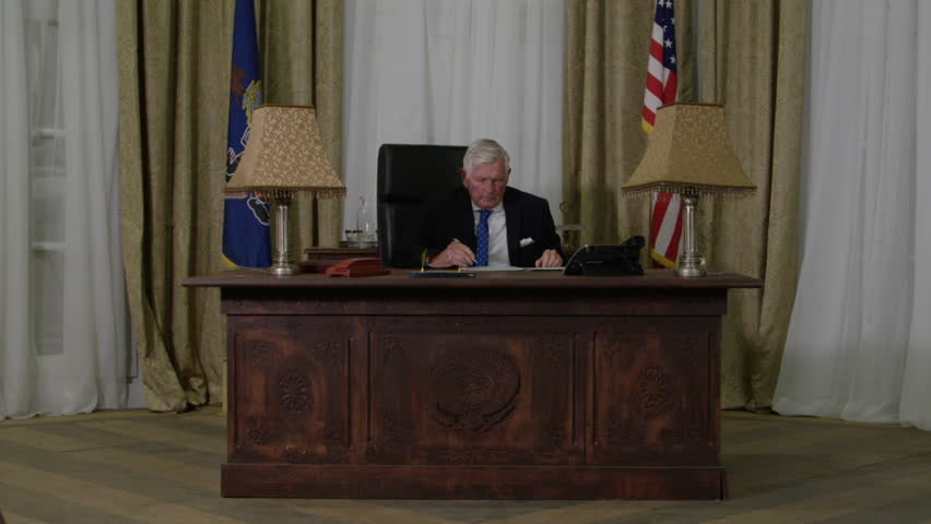 Close Up Getting Up From Desk In Oval Office