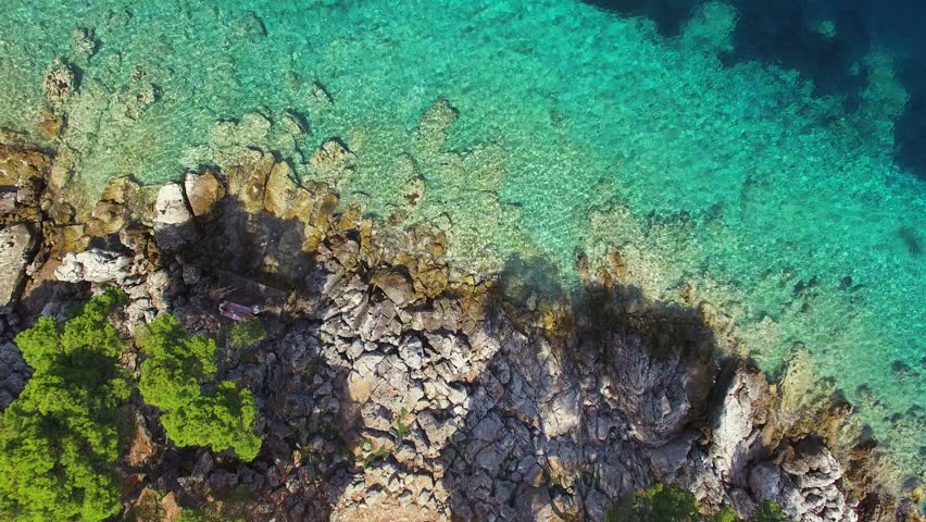 Stock Video Clip of Aerial view of turquoise shallows contrasted with ...