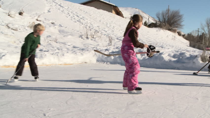 Hd00 14four Young Kids Play Hockey On Backyard Ice Rink