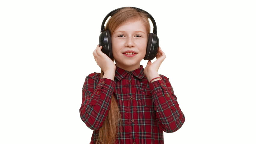 Lovely Active Elementary School Aged Caucasian Girl Listening Music Through Headphones Dancing Smiling On White Lovely Active Elementary School Aged Caucasian Girl Listening Music Through Headphones Dancing Smiling On White