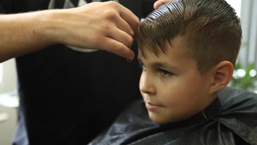 Young Boy Having A Haircut At The Barbershop. Kid Getting A Haircut ...