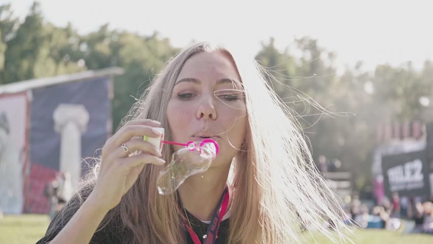 Beautiful Young Blonde Girl Blowing Soap Bubbles Gor