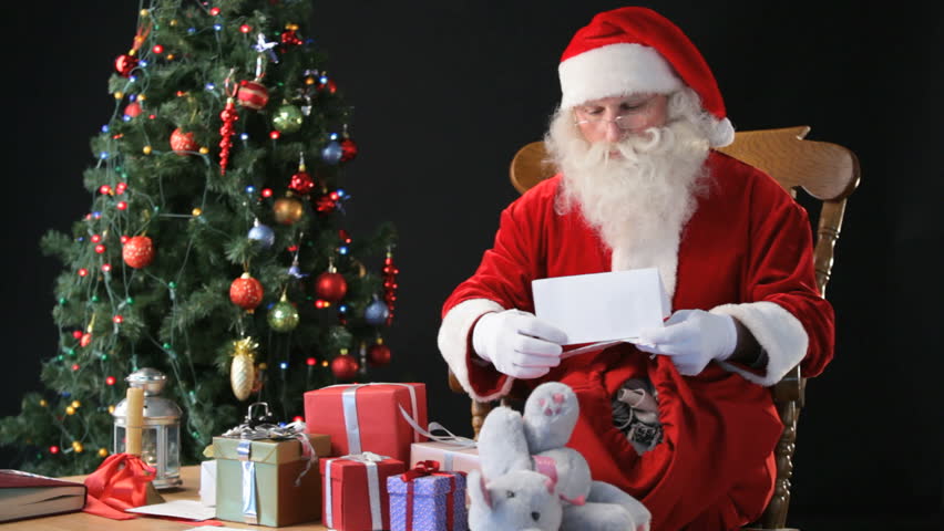 Santa Claus Sitting In A Rocking-chair With A Christmas Tree In The ...