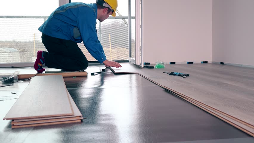 Adult Male Worker Installing Laminate Stock Footage Video 100
