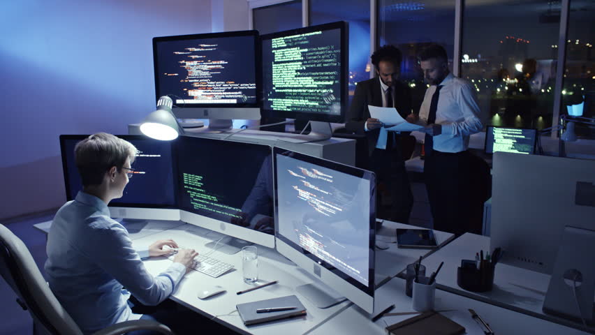Female Programmer Typing Computer Code On Computer Workstation In The ...