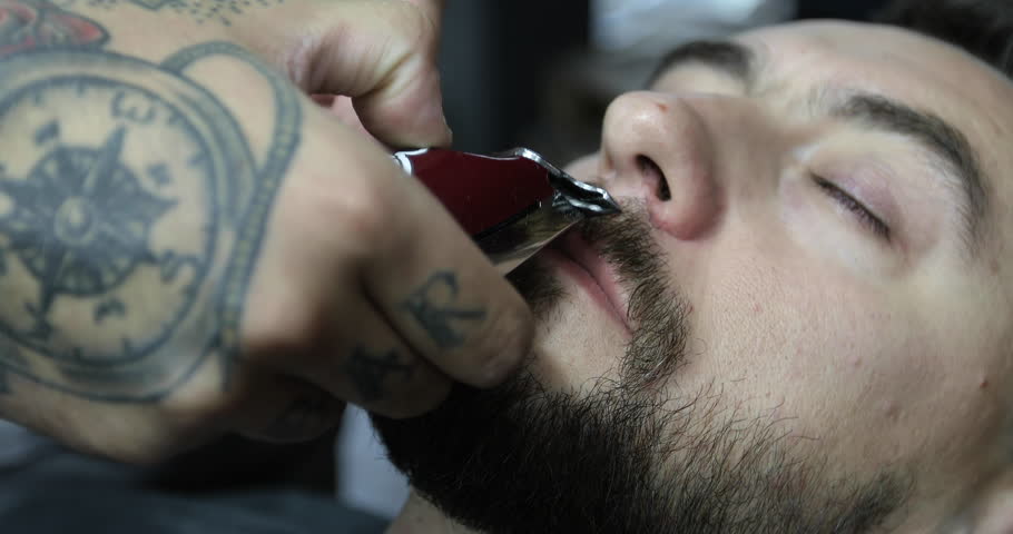 close up view of an intelligent handsome italian barber in a white close up view of an intelligent handsome italian barber in a white