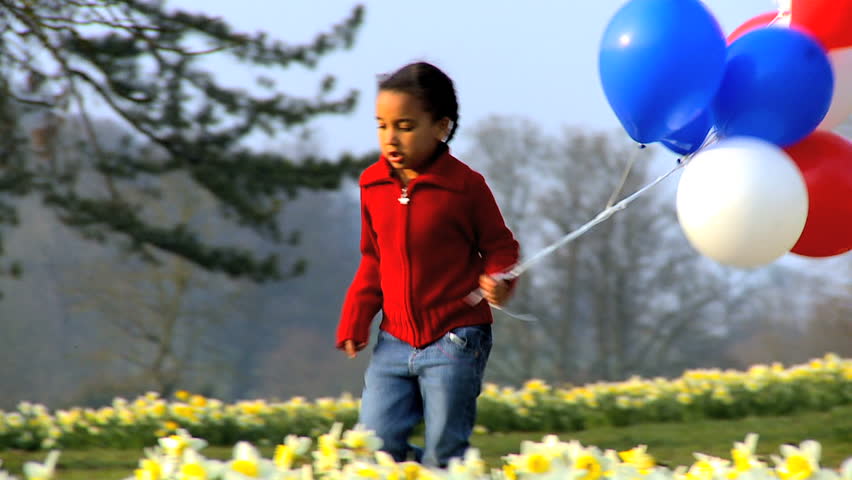 Cute African American Child Playing Outdoors With Balloons Stock ...