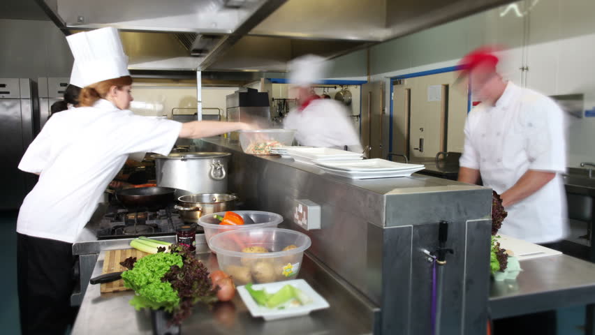 Restaurant Kitchen Video waitress collects her order from the chef in a busy hotel or Restaurant Kitchen Video waitress collects her order from the chef in a busy hotel or
