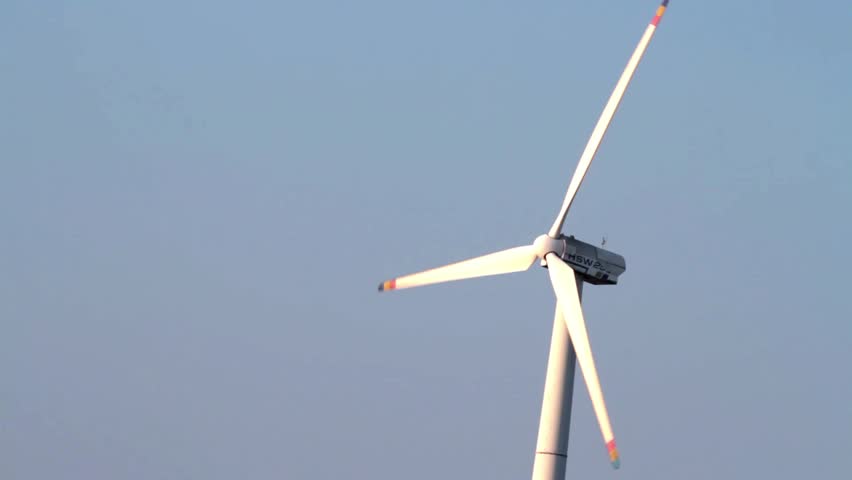 Single Blade Wind Turbine In Function And Plants Moving On A Windy Day