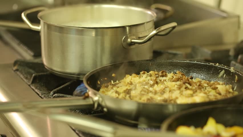 Restaurant Kitchen Video close-up of chef hands cooking and preparing in restaurant kitchen Restaurant Kitchen Video close-up of chef hands cooking and preparing in restaurant kitchen