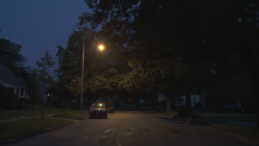 Driving plate, side view, night.  Tree-lined road through well-tended middle class suburban neighborhood with 1940s & 1950s era Cape Cods, bungalows and similar homes.  Recorded on Tyler Mini Gyro.