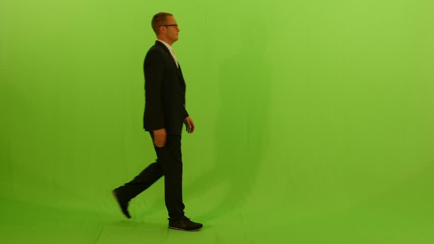 Man Walking Against Green Screen. Stock Footage Video (100% Royalty