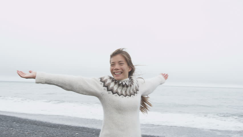 Dancing Free Happy Woman On Iceland Dancing Of Joy In Icelandic Sweater On Black Sand Beach