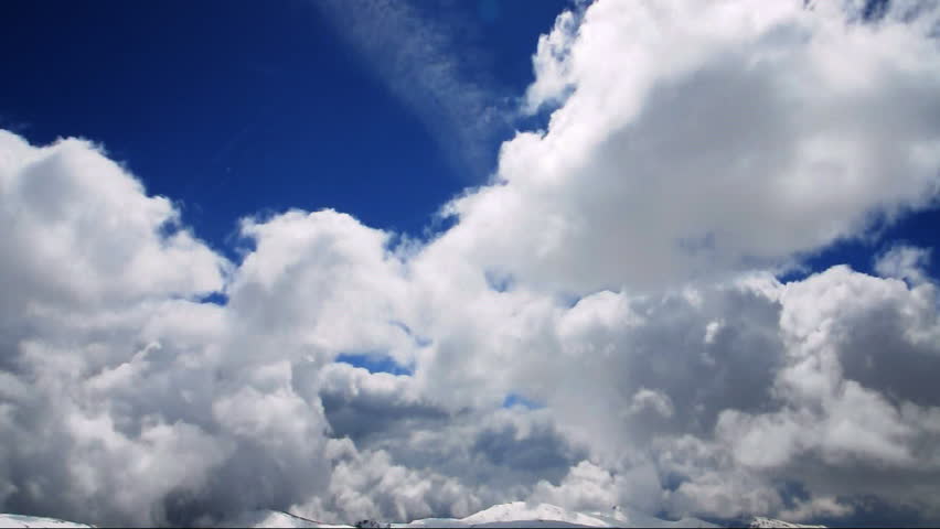 Loop Features Puffy White Clouds Fly Over A Deep Blue Sky In Faster ...