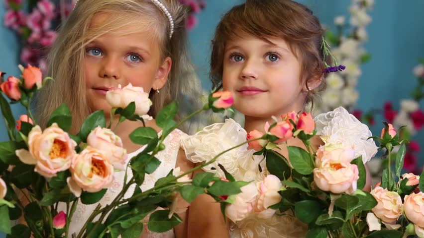 Two Little Girls In Dresses Hold Bouquets Of Roses In Pitchers And ...