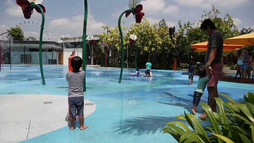 Garden By The Bay Water Park kuala lumpur. malaysia - circa feb 2015: tourists ride in a horse Garden By The Bay Water Park kuala lumpur. malaysia - circa feb 2015: tourists ride in a horse